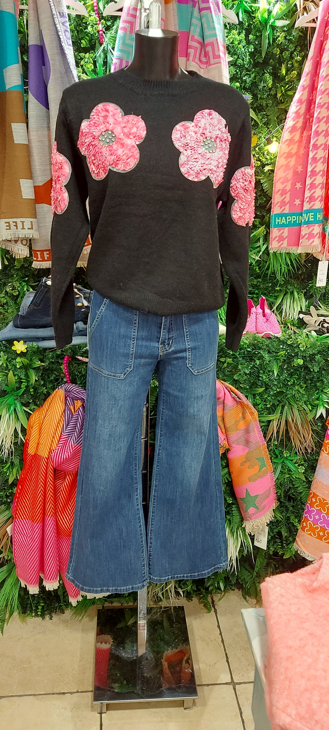 A jiko black knit sweater and pink flowerspink